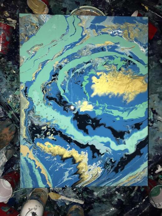 painting made by a marbling technique with blue, black, and gold paints.