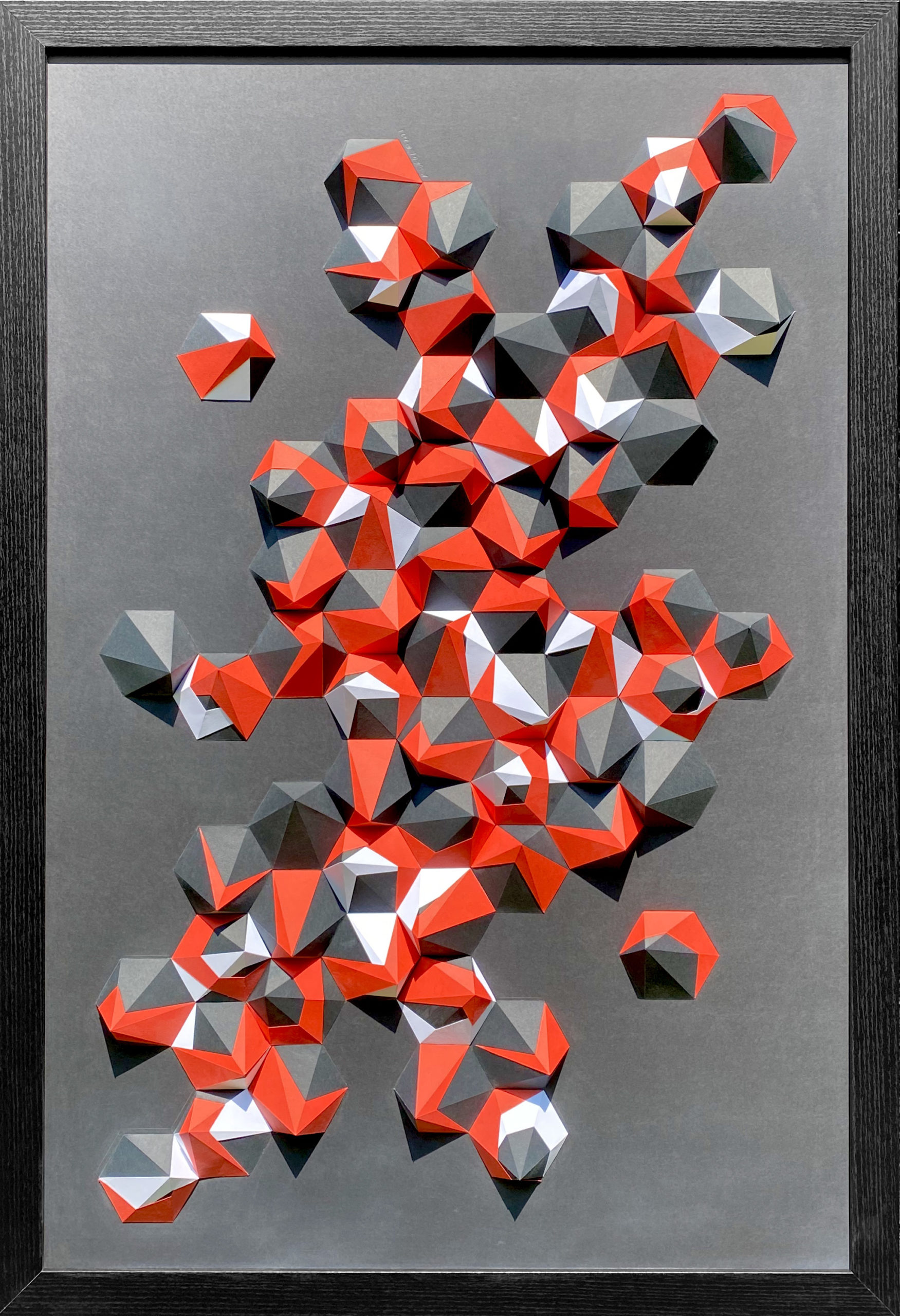 A cluster of geometric shapes that have the appearance of a crystal formation in a digital form. The colors on the page are orange, silver and black